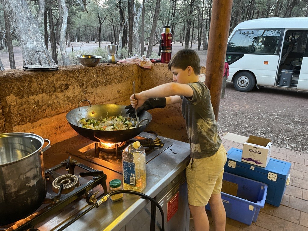 Alex cooking stir-fry at camp