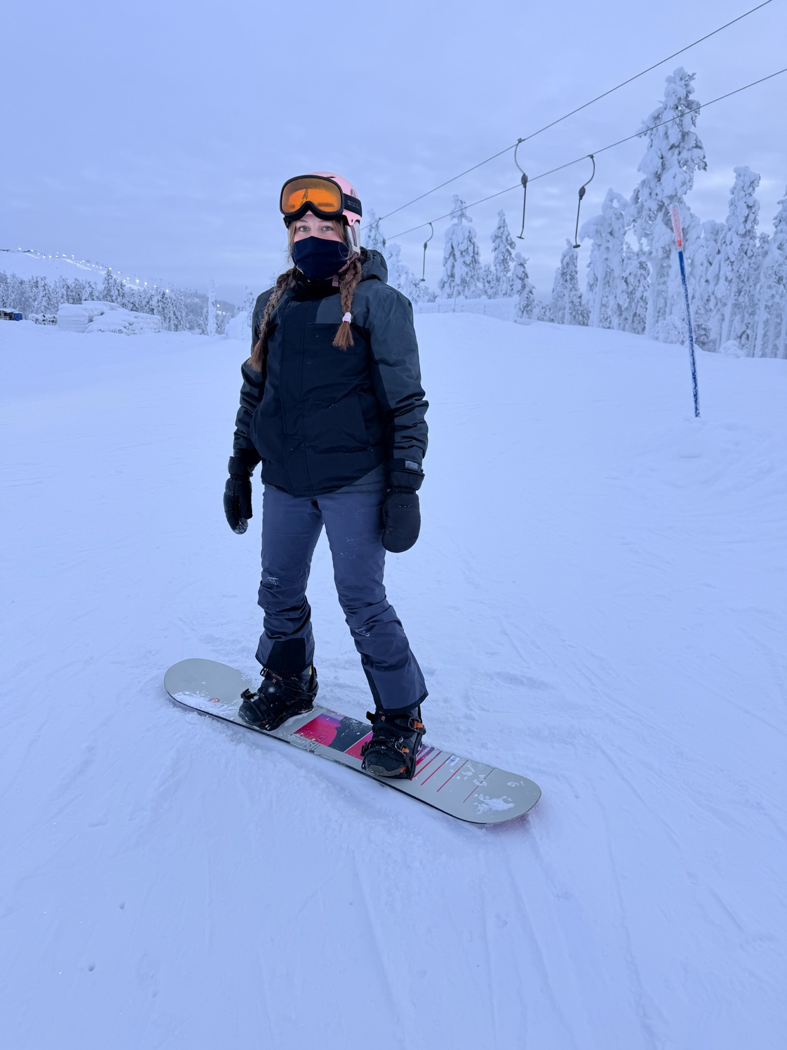 Bella on the snowboard — she&rsquo;s getting the hang of it